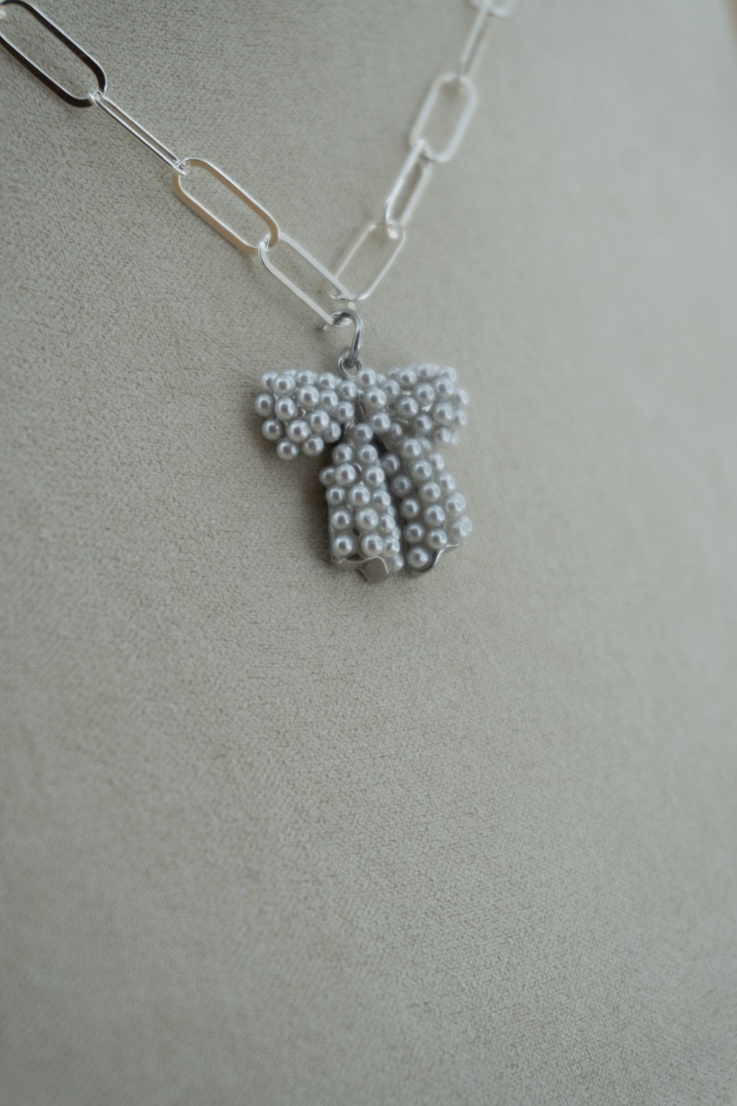 pearl bow (!!) silver charm
